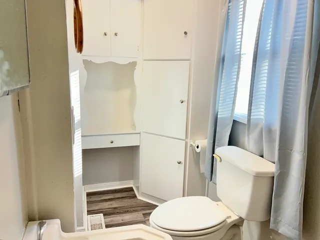a bathroom with a toilet and a shower