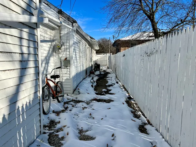 a view of a patio with wooden fence