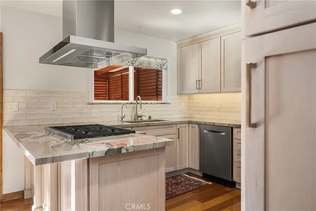 a kitchen with stainless steel appliances granite countertop a stove sink and cabinets