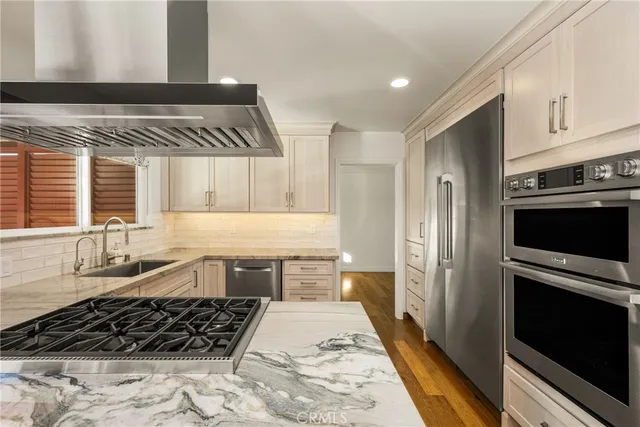 a kitchen with granite countertop a stove and a refrigerator