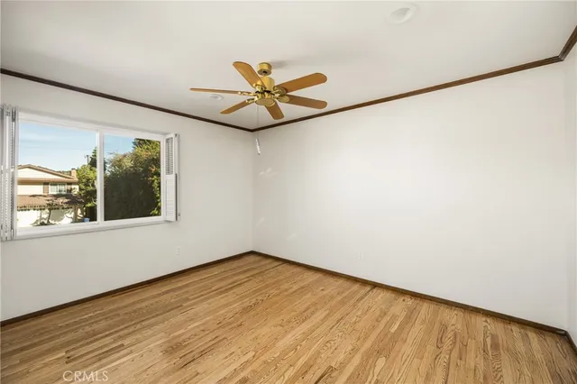 a view of a big room with wooden floor closet and fan