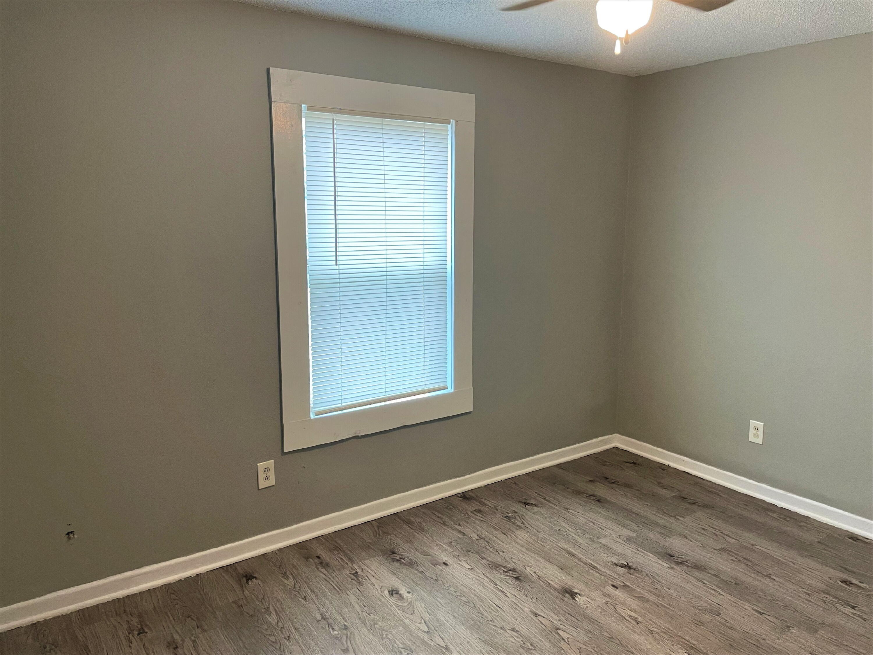 2718 East 10th Street Lubbock, TX 79403 - Photo 4 of 9 an empty room with a window