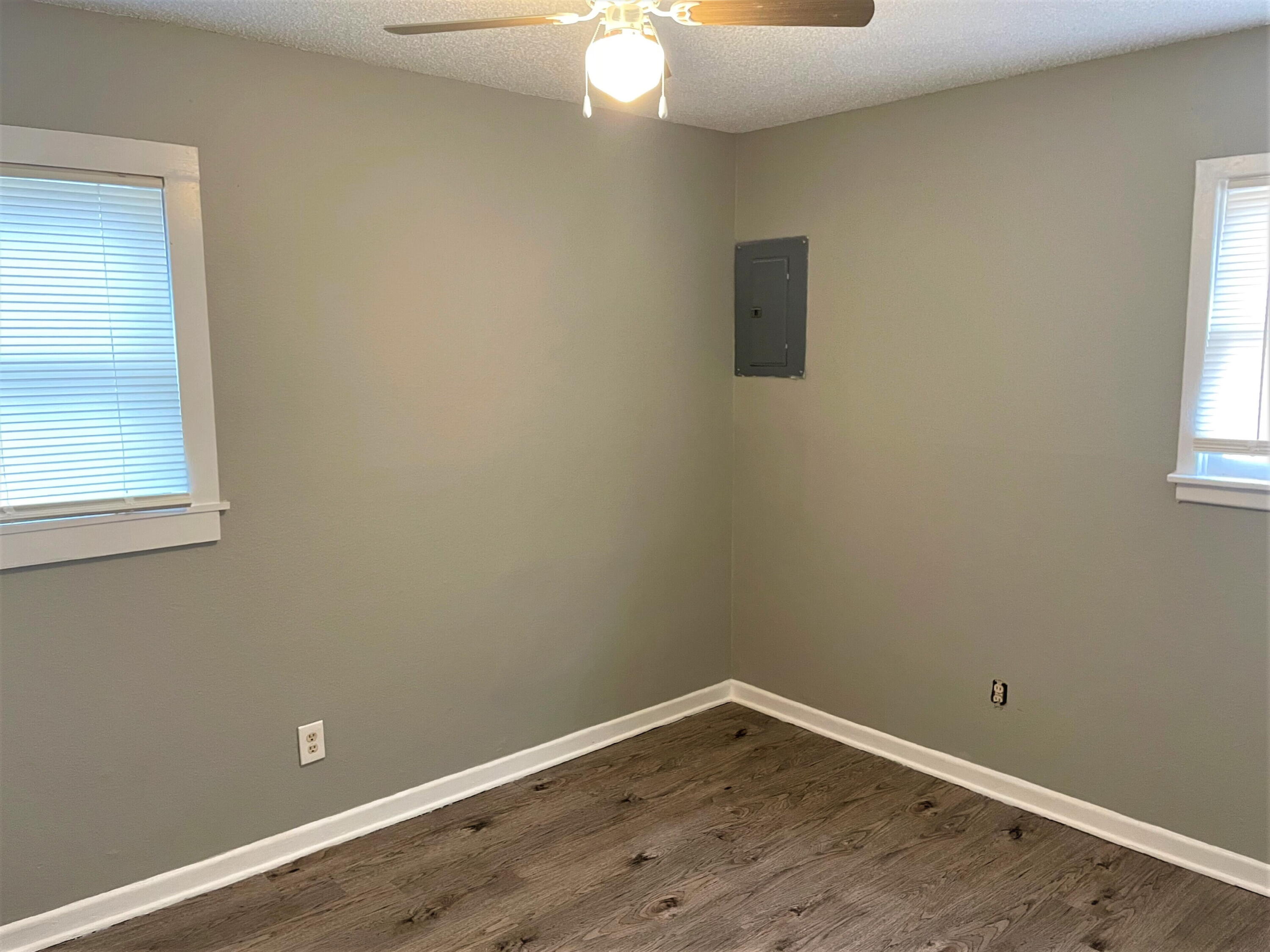 2718 East 10th Street Lubbock, TX 79403 - Photo 5 of 9 a view of a room with wooden floor and windows