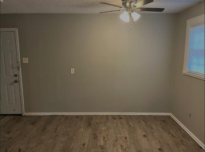 2718 East 10th Street Lubbock, TX 79403 - Photo 9 of 9 an empty room with a window and a fan