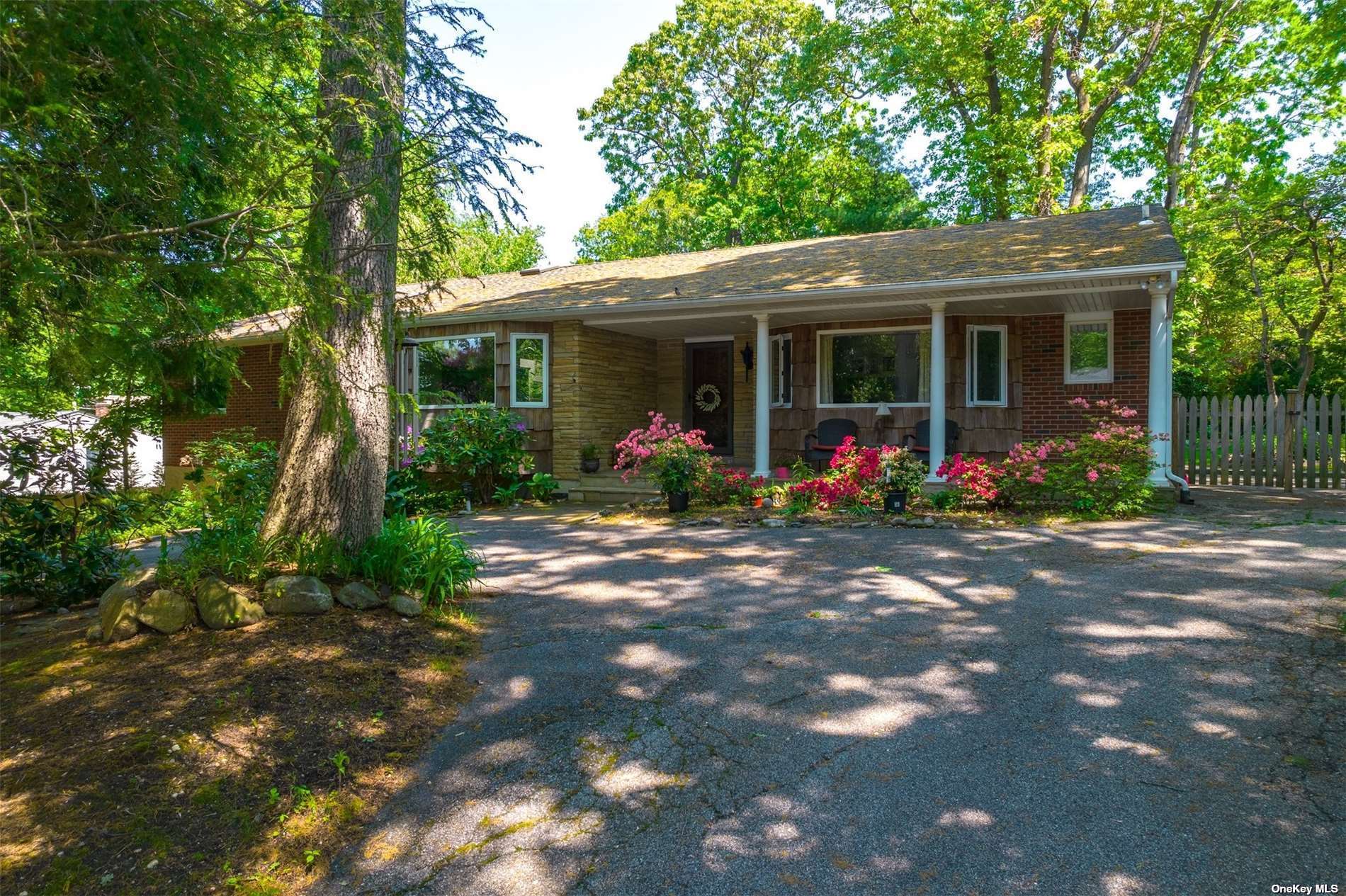4 Pegs Lane Cold Spring Harbor, NY 11724 - Photo 1 of 1 a front view of a house with garden