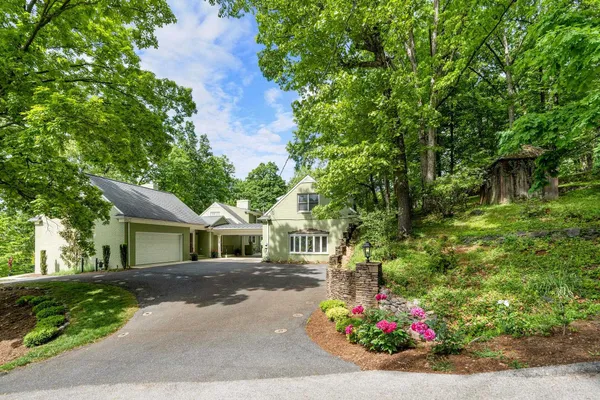 a front view of a house with a yard and a garage