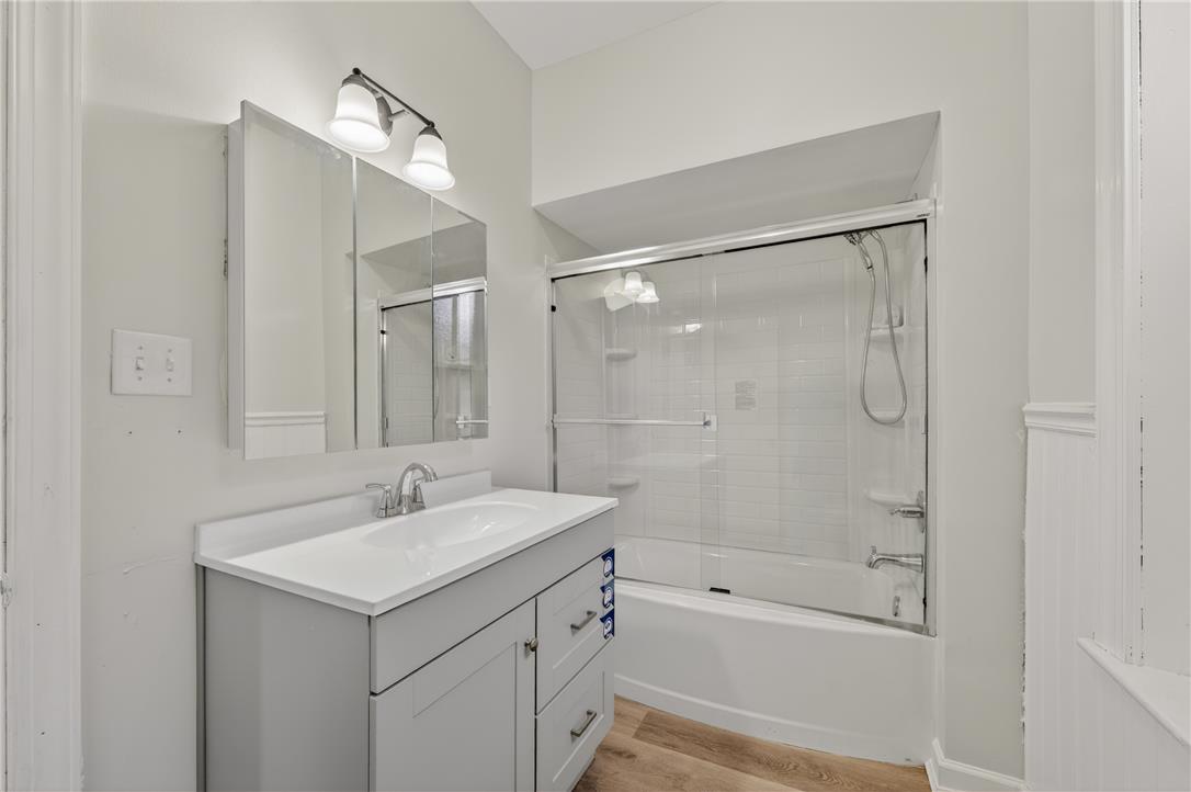 65 2nd Street Slatington, PA 18080 - Photo 34 of 46 This bathroom features a contemporary vanity with an integrated sink, complementing the sleek glass-enclosed shower-tub combo.
