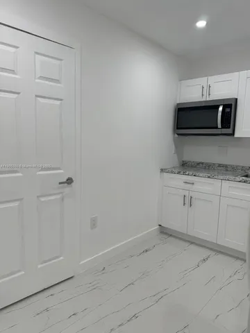 a kitchen with a sink and microwave