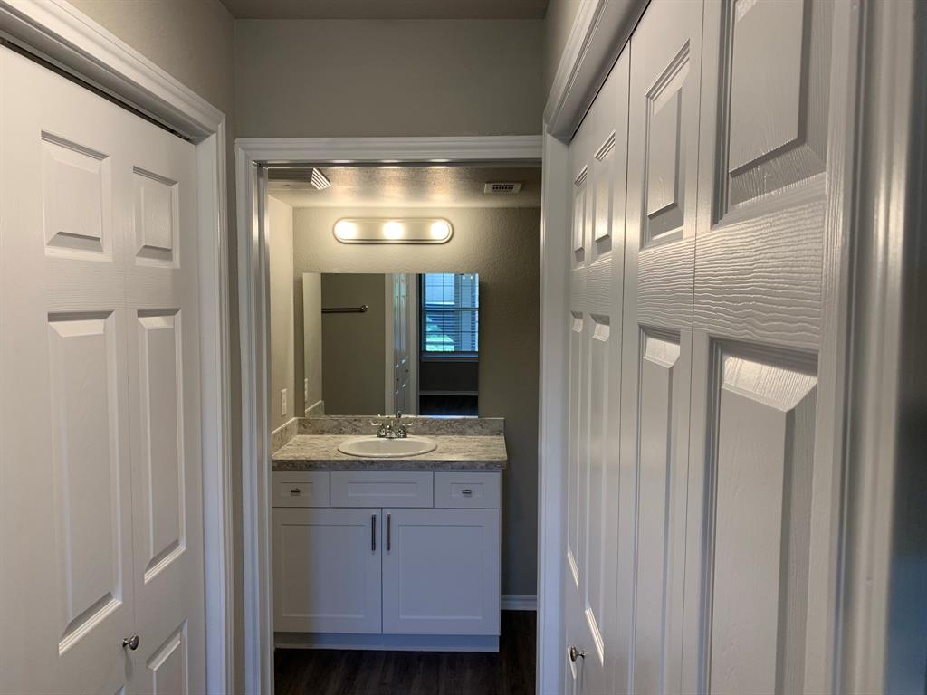 6108 Abrams Road, Unit 514 Dallas, TX 75231 - Photo 7 of 9 a bathroom with a granite countertop sink and a mirror