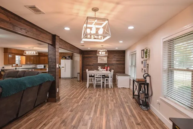 a dining room with furniture window and wooden floor