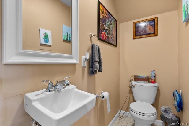 448 Old Mountain Road Port Jervis, NY 12771 - Photo 11 of 29 a bathroom with a toilet a sink and mirror