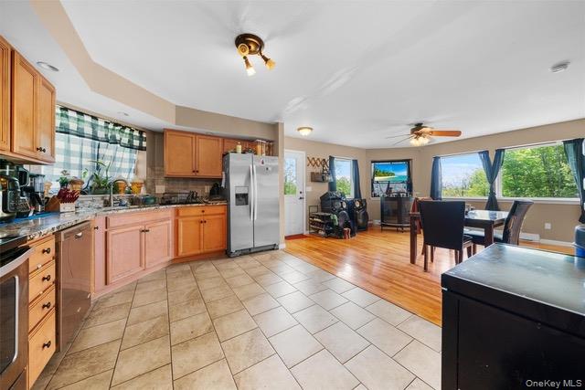 448 Old Mountain Road Port Jervis, NY 12771 - Photo 15 of 29 a kitchen with stainless steel appliances a stove a sink a refrigerator cabinets and dining table