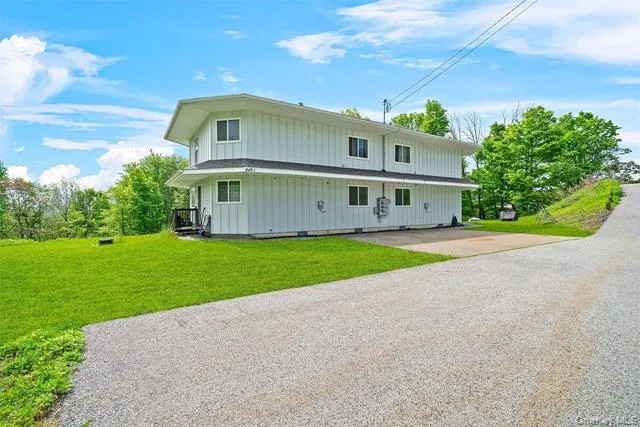 a front view of house with yard and green space