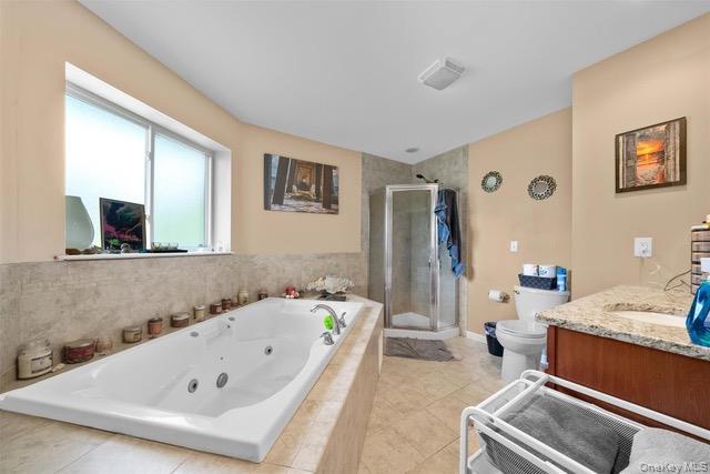 448 Old Mountain Road Port Jervis, NY 12771 - Photo 9 of 19 Bathroom with vanity, a jetted tub, a stall shower, and light tile patterned flooring