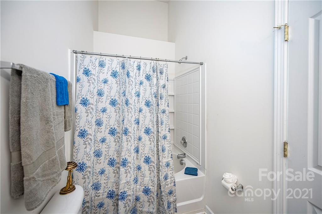1135 Market Street, Unit 552 Fort Mill, SC 29708 - Photo 14 of 27 a bathroom with a shower curtain and a toilet