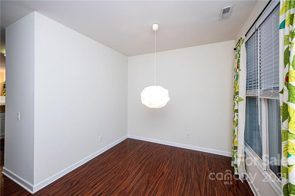 1135 Market Street, Unit 552 Fort Mill, SC 29708 - Photo 5 of 27 a view of a room with wooden floor and brick walls