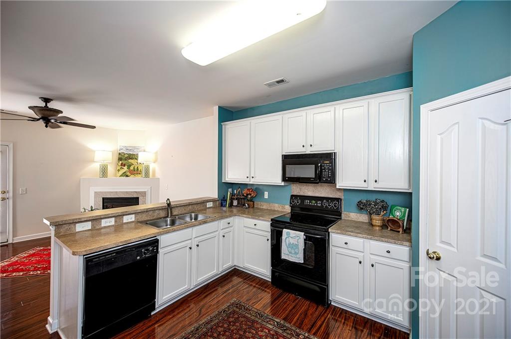 1135 Market Street, Unit 552 Fort Mill, SC 29708 - Photo 6 of 27 a kitchen with a sink stove and cabinets