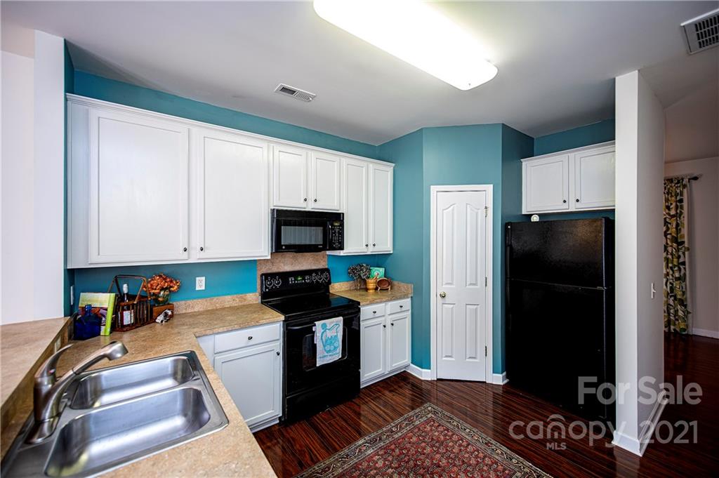 1135 Market Street, Unit 552 Fort Mill, SC 29708 - Photo 7 of 27 a kitchen with stainless steel appliances a refrigerator a stove a microwave and cabinets