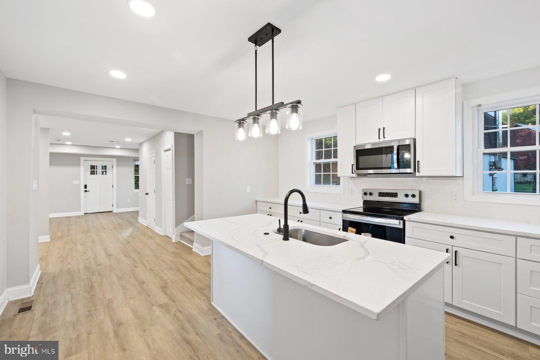 8109 Old Hagerstown Road Middletown, MD 21769 - Photo 11 of 54 a kitchen with kitchen island a sink appliances and cabinets