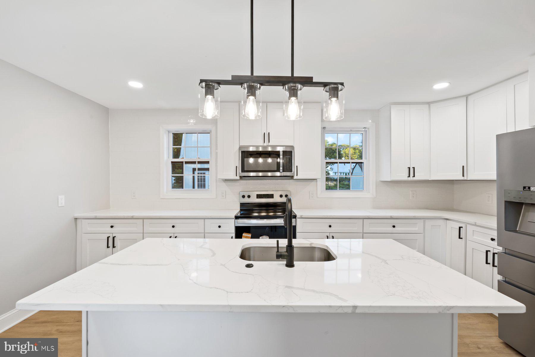 8109 Old Hagerstown Road Middletown, MD 21769 - Photo 12 of 54 a kitchen with stainless steel appliances a sink stove and refrigerator