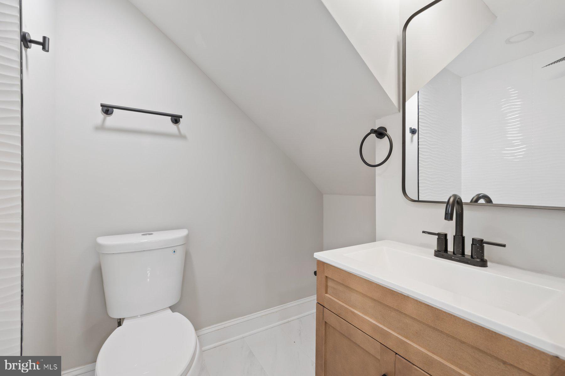 8109 Old Hagerstown Road Middletown, MD 21769 - Photo 13 of 54 a bathroom with a toilet sink and mirror