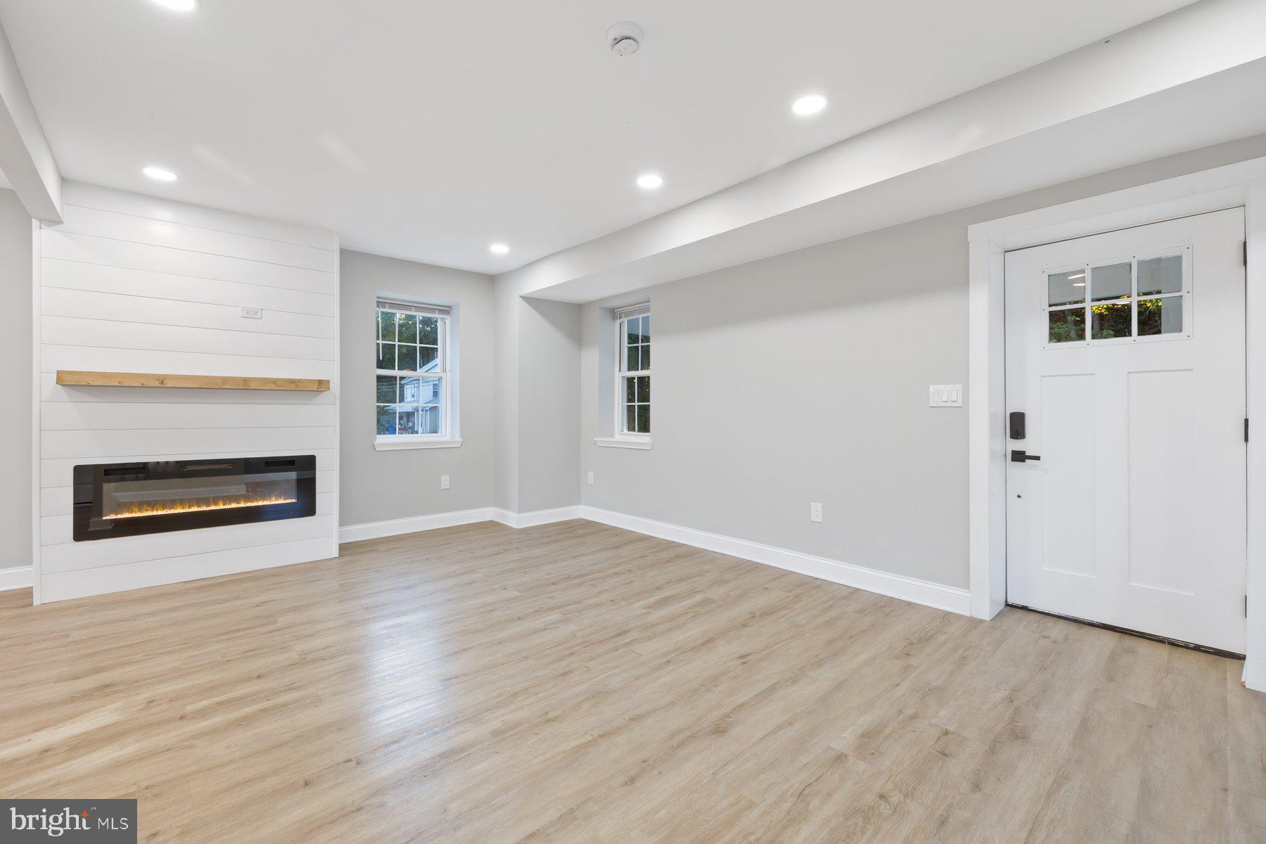 8109 Old Hagerstown Road Middletown, MD 21769 - Photo 3 of 54 an empty room with wooden floor fireplace and windows