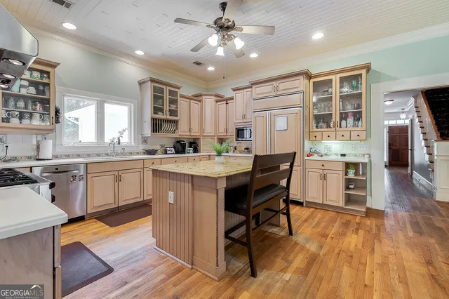 a kitchen with stainless steel appliances granite countertop a sink stove and cabinets