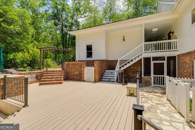 a view of a lush green forest with trees and houses