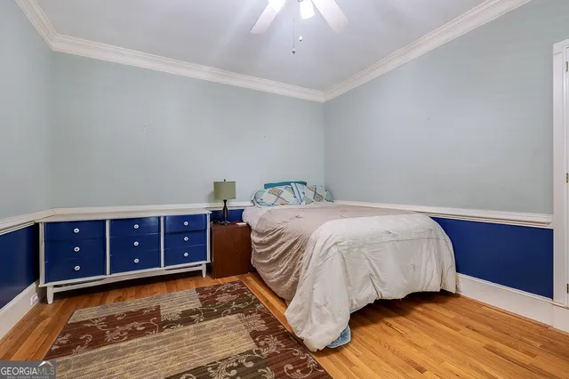 a kitchen with a sink a counter space dining table and stainless steel appliances