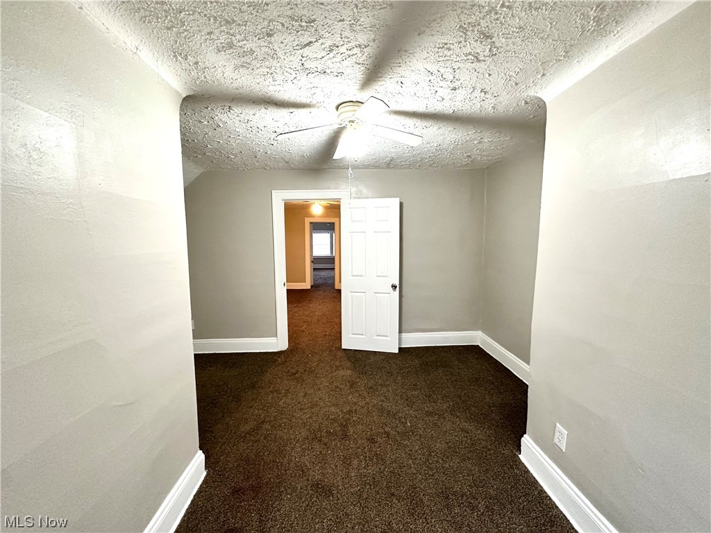 3228 Berkeley Road Cleveland, OH 44118 - Photo 12 of 26 Bedroom 3rd floor dark carpet, a textured ceiling, and ceiling fan