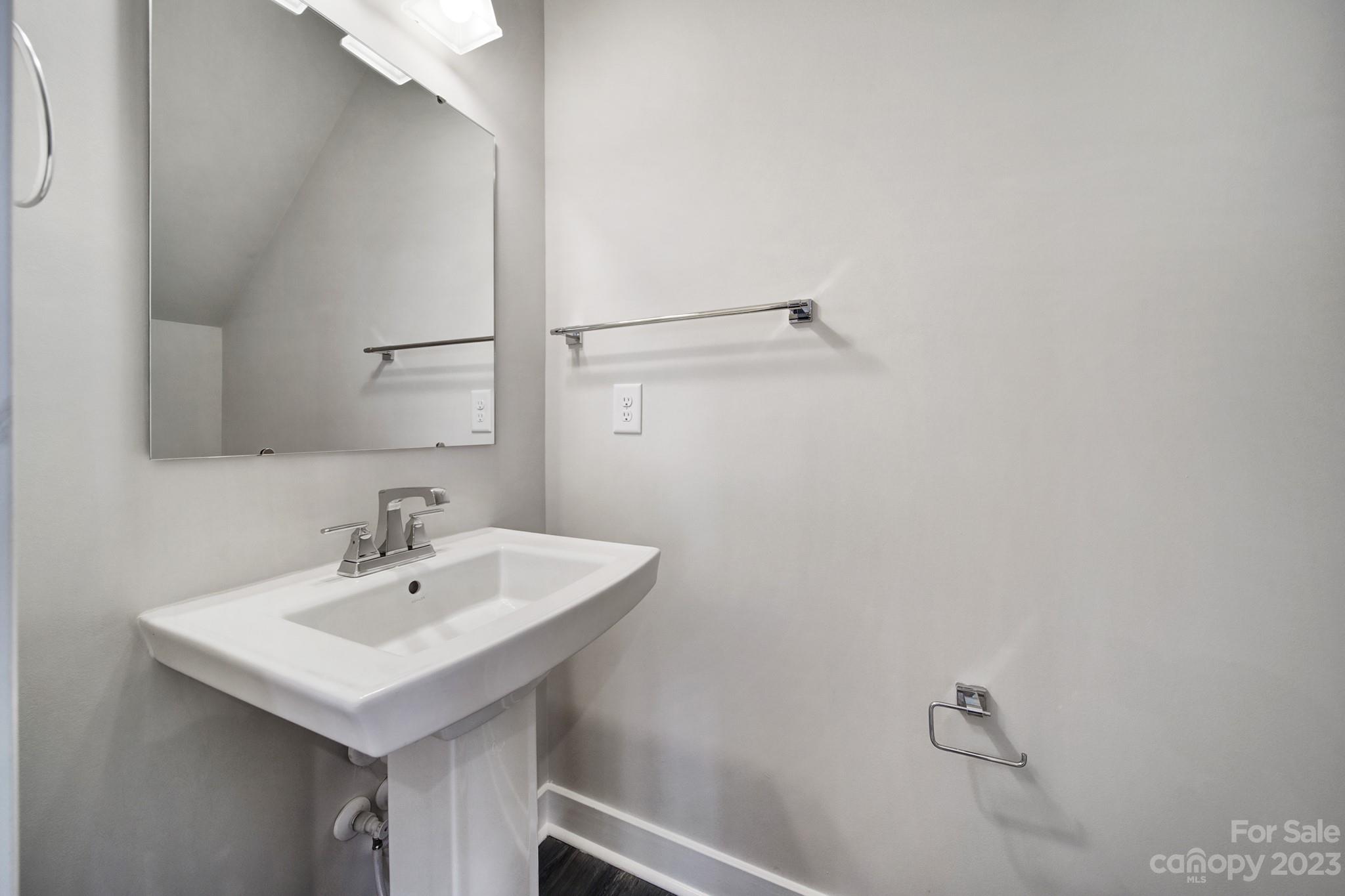 622 Crudent Road Tega Cay, SC 29708 - Photo 18 of 40 a white sink sitting under a bathroom mirror