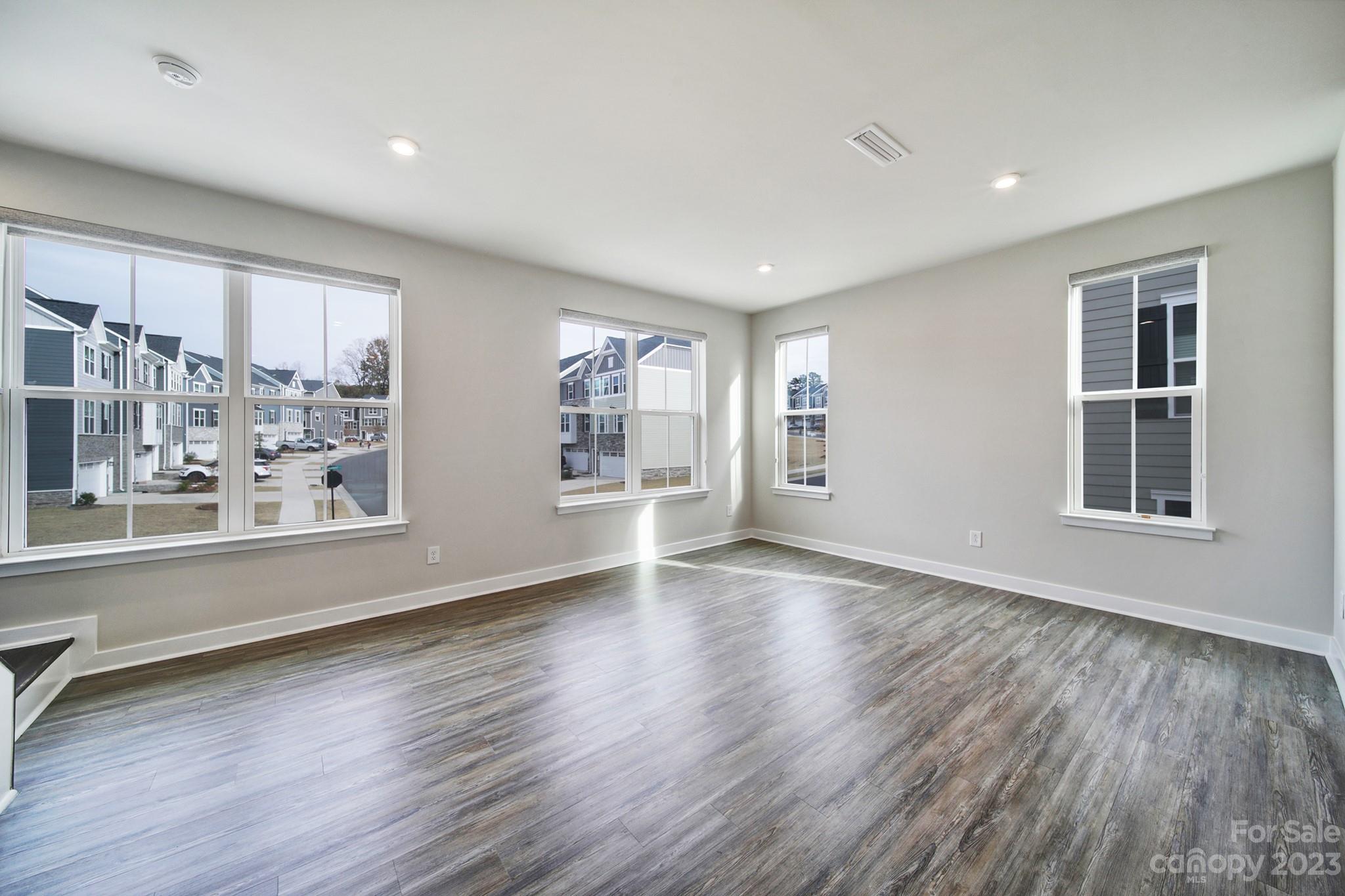 622 Crudent Road Tega Cay, SC 29708 - Photo 19 of 40 a view of an empty room with a window and wooden floor