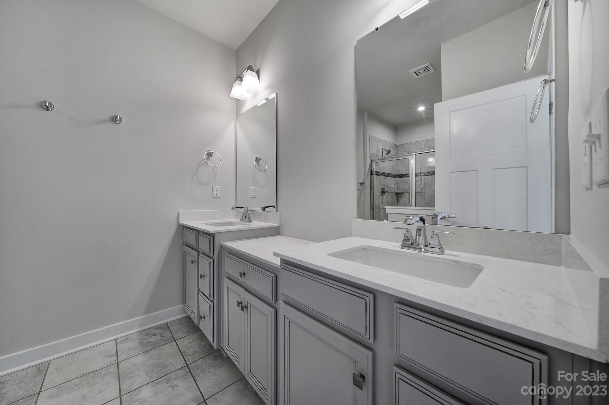 622 Crudent Road Tega Cay, SC 29708 - Photo 35 of 40 a bathroom with a sink double vanity granite and a mirror