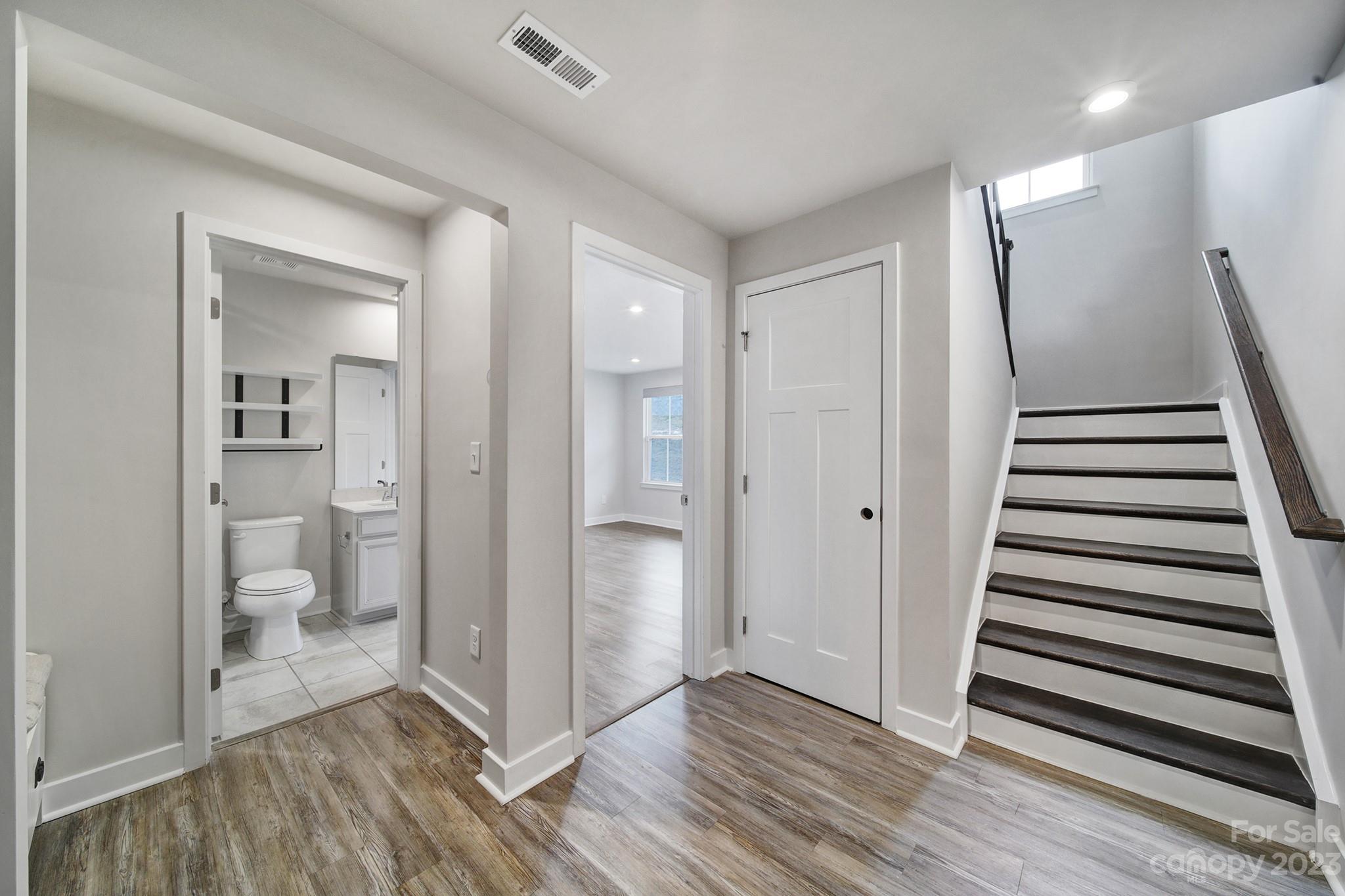 622 Crudent Road Tega Cay, SC 29708 - Photo 9 of 40 a view of a room with wooden floor and a bathroom