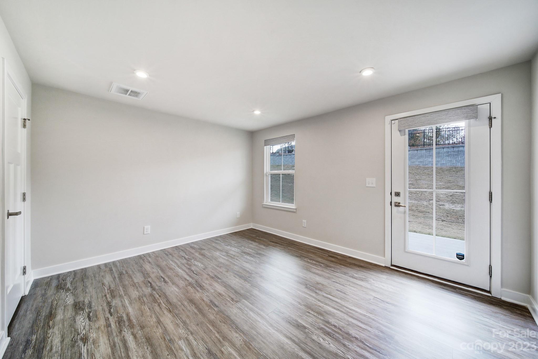 622 Crudent Road Tega Cay, SC 29708 - Photo 10 of 40 an empty room with wooden floor and windows