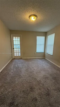 an empty room with a empty space and windows