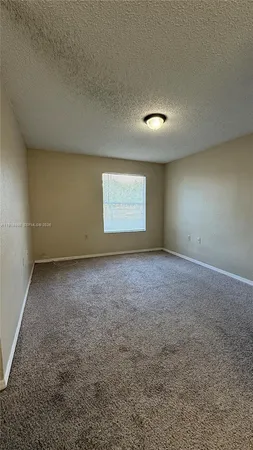 an empty room with a empty space and windows