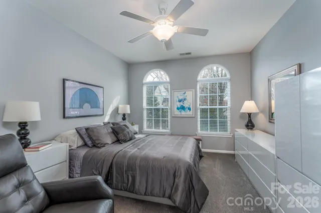 a bedroom with a bed and a large window