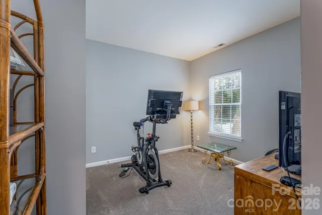 a room with gym equipment and a window