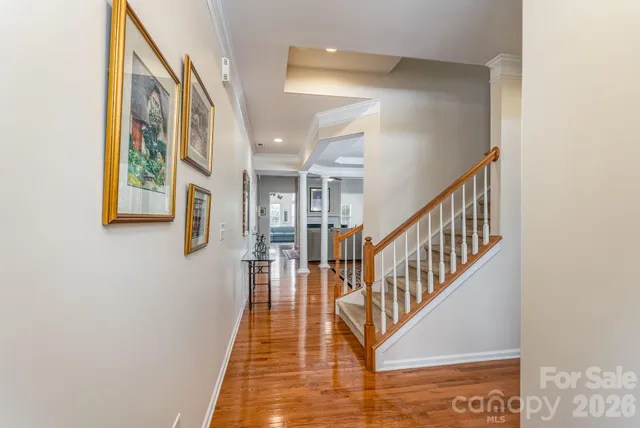 a view of entryway and hall with wooden floor