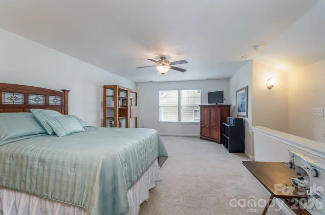 a bedroom with a large bed and a book shelf