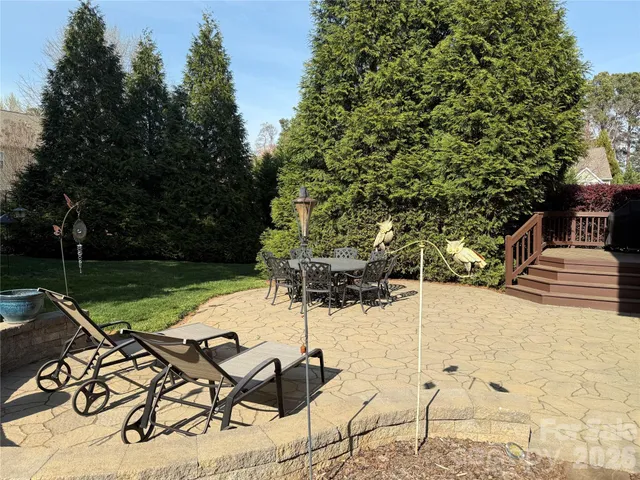 a view of swimming pool with a table and chairs