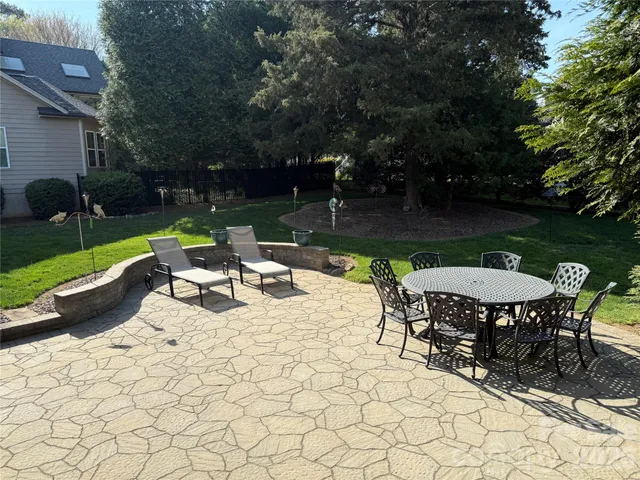 a view of a backyard with sitting area