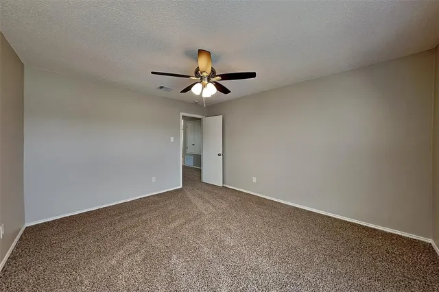 a view of room with a ceiling fan and window