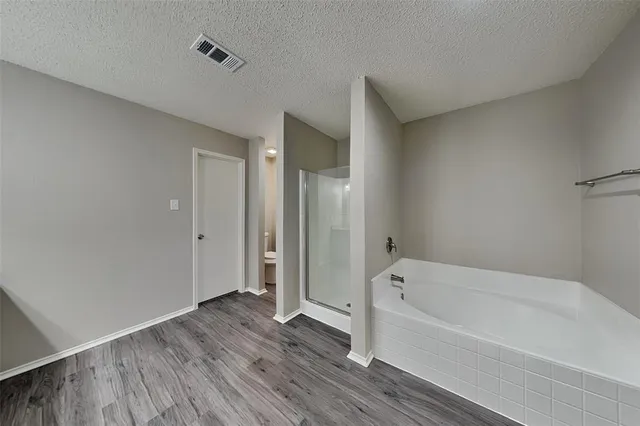 a bathroom with a bathtub and a shower