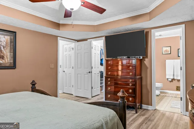 a bedroom with a bed and a flat tv screen