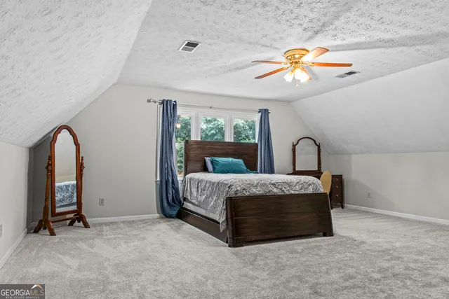 a living room with furniture a chandelier and a large window