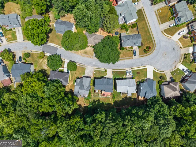 an aerial view of multiple houses with yard