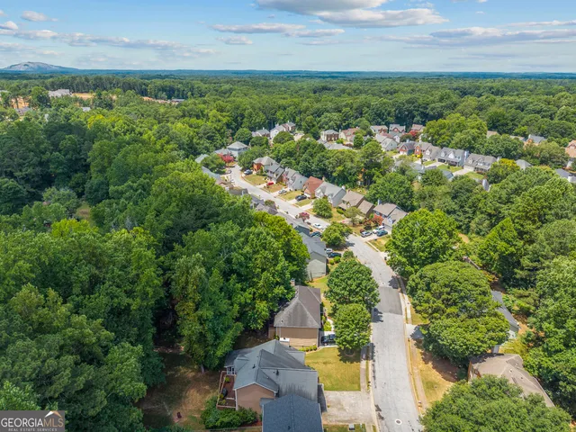 an aerial view of a houses with yard and lake view