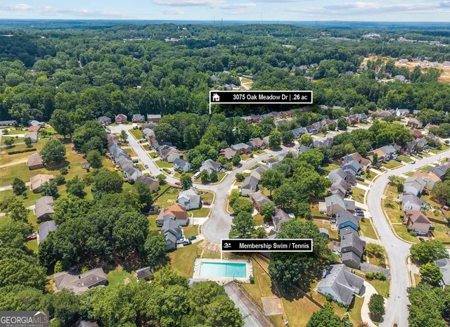an aerial view of a house with a yard and lake view